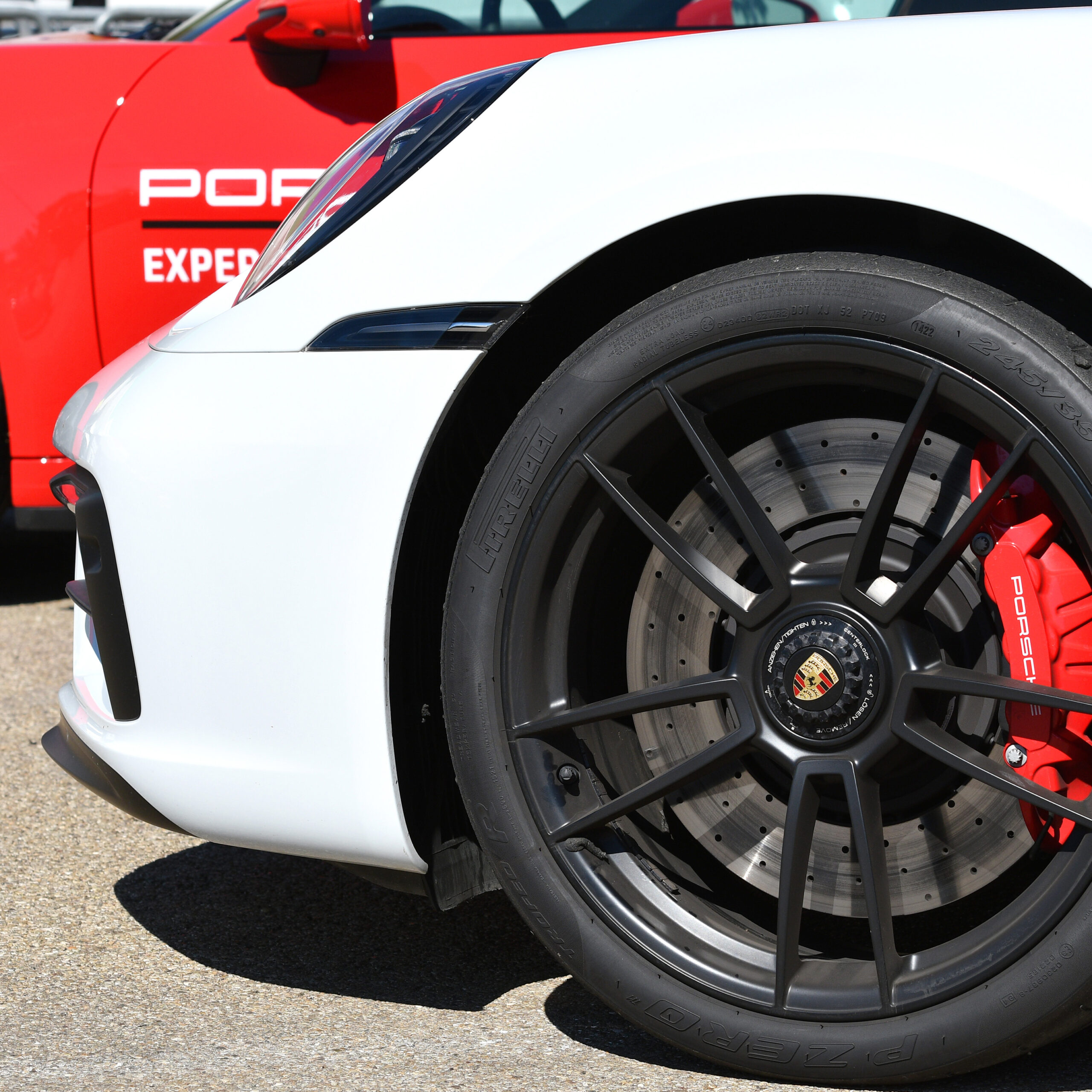 Mugello Circuit, Italy 23 September 2022: Detail of alloy wheel with red caliper of a Porsche 911 GT3 on display in the Paddock of Mugello circuit during Porsche Sports Cup Suisse event 2022. Italy.